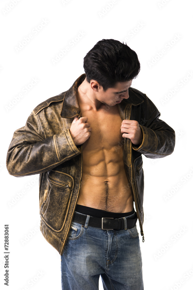 Handsome young man wearing leather jacket on naked torso Handsome young man wearing leather jacket on naked torso