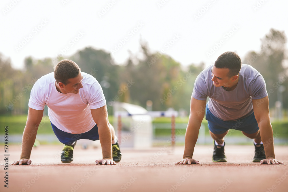 Two young athletes doing push-ups