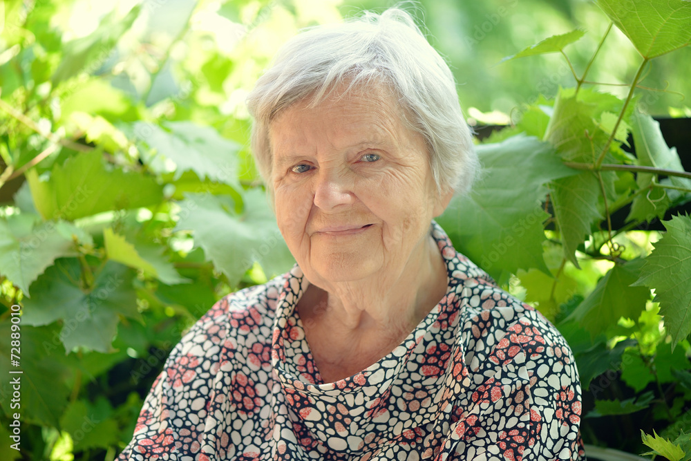Senior woman smiling and dreaming in garden. Senior woman smiling and dreaming in garden.
