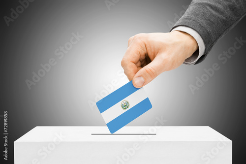 Male inserting flag into ballot box - El Salvador