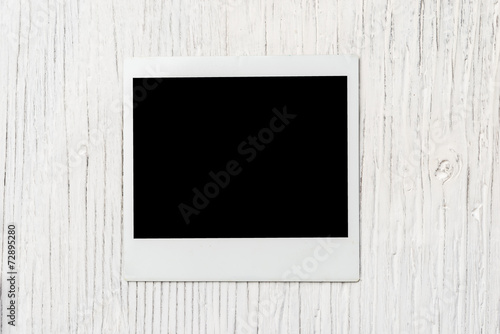instant photo frame wooden background