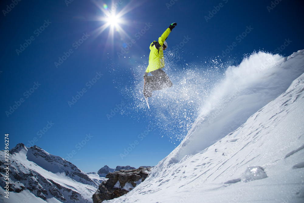 Snowboarder in high mountains