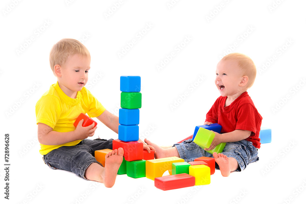two brothers build toy building of colored cubes two brothers build toy building of colored cubes