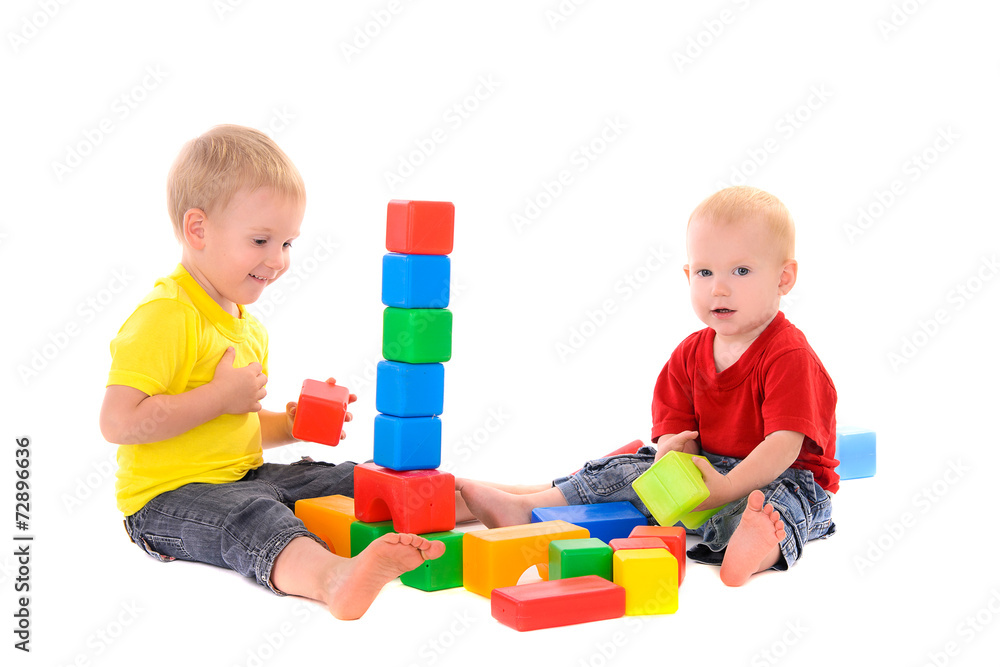 two brothers build toy building of colored cubes two brothers build toy building of colored cubes