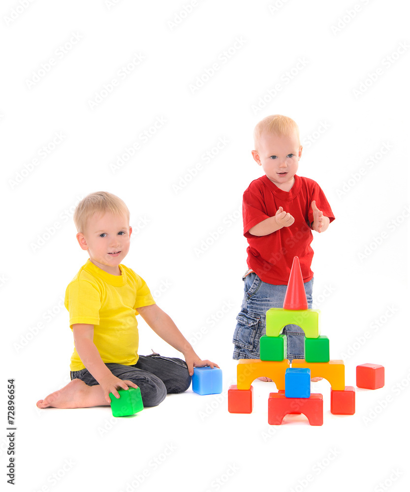two brothers build toy building of colored cubes two brothers build toy building of colored cubes