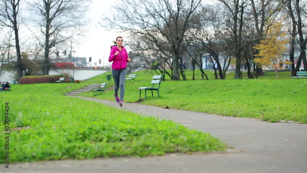 Beautiful young woman jogging in city park Beautiful young woman jogging in city park