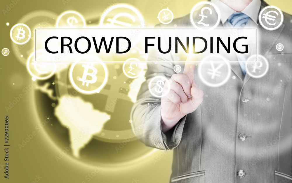 Businessman pushes virtual crowd funding button Businessman pushes virtual crowd funding button