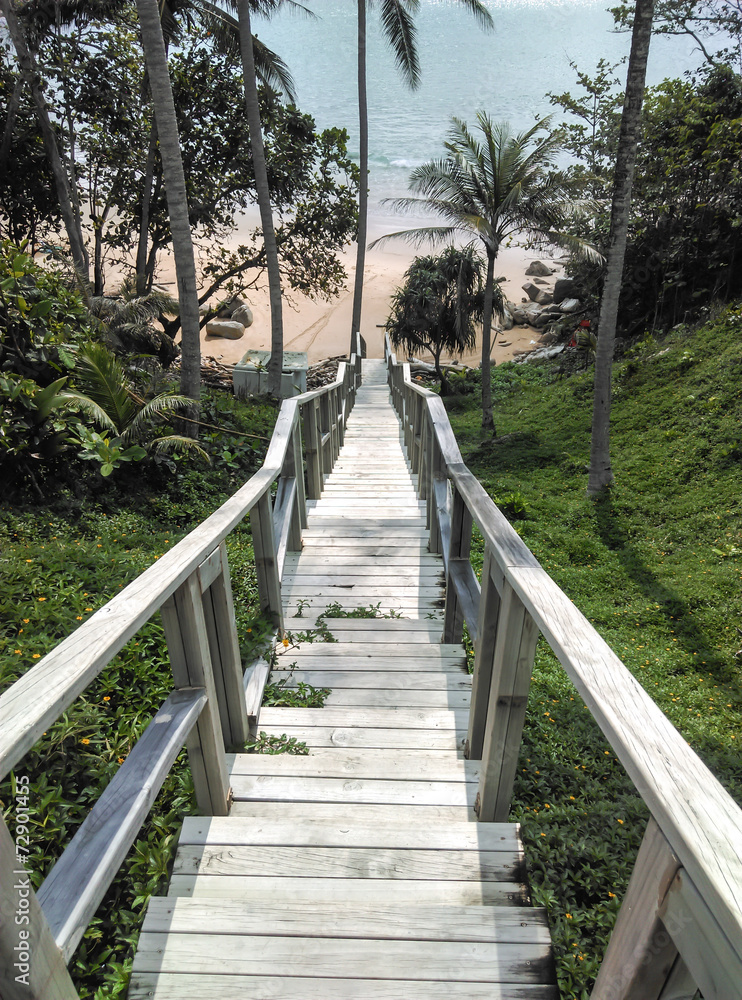 Wooden staircase down to the beautiful and relax sandy beach. Wooden staircase down to the beautiful and relax sandy beach.