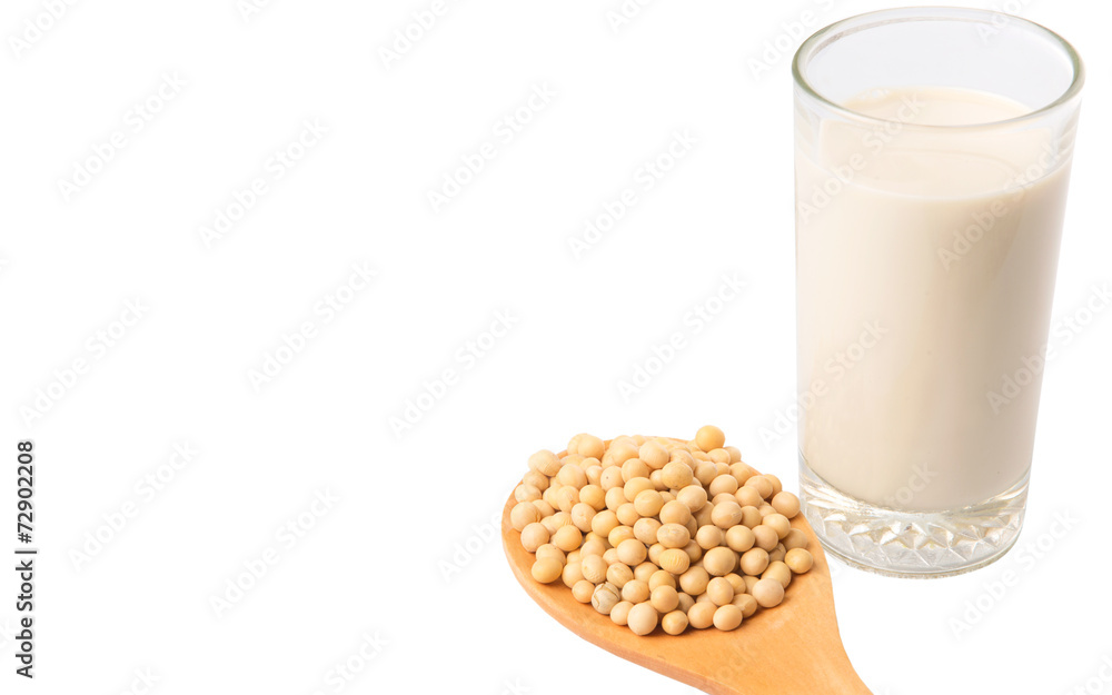 Soybean in a white bowl and a glass of soybean milk over white Soybean in a white bowl and a glass of soybean milk over white