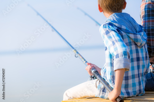 Close-up of hands of a boy with a fishing rod