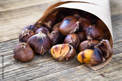 Delicious roasted chestnuts on wooden board