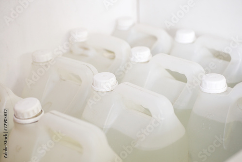 фотографія White plastic canister with liquid
