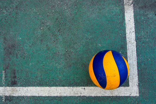 Old volleyball on a dirty court