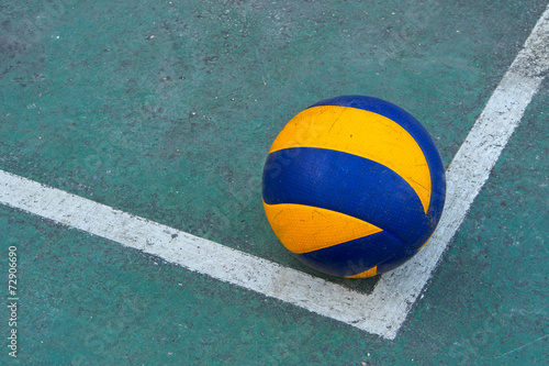 Old volleyball on a dirty court