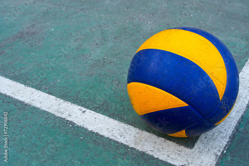 Old volleyball on a dirty court