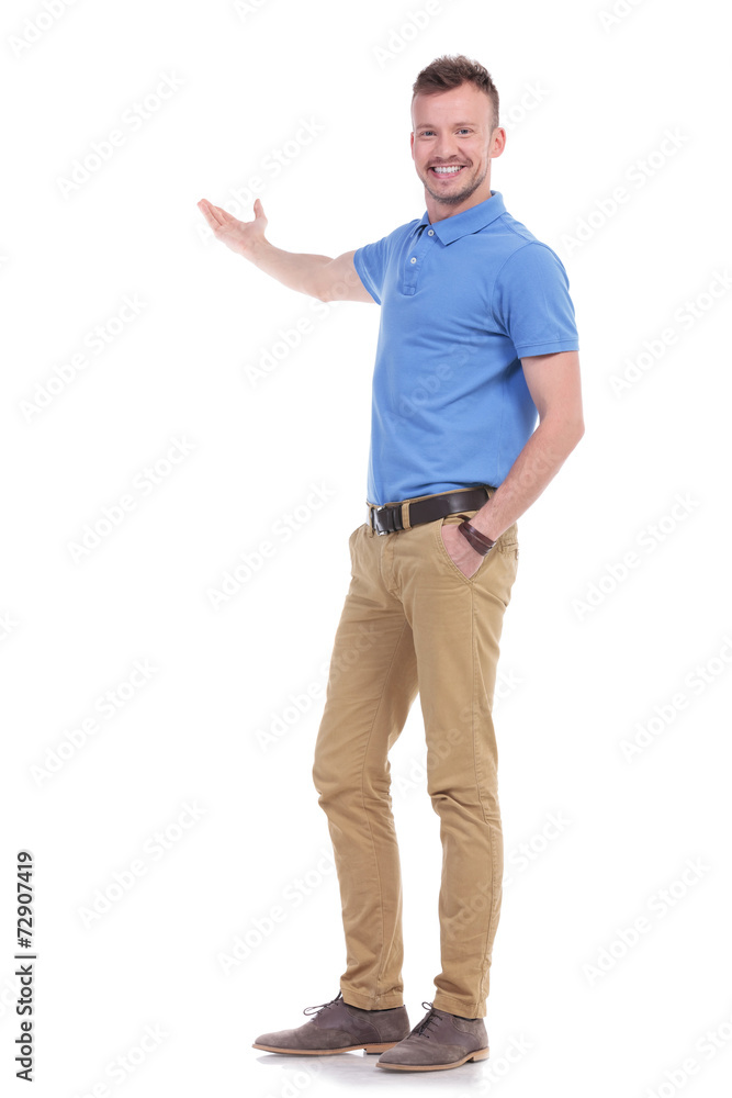happy casual young man presents something happy casual young man presents something