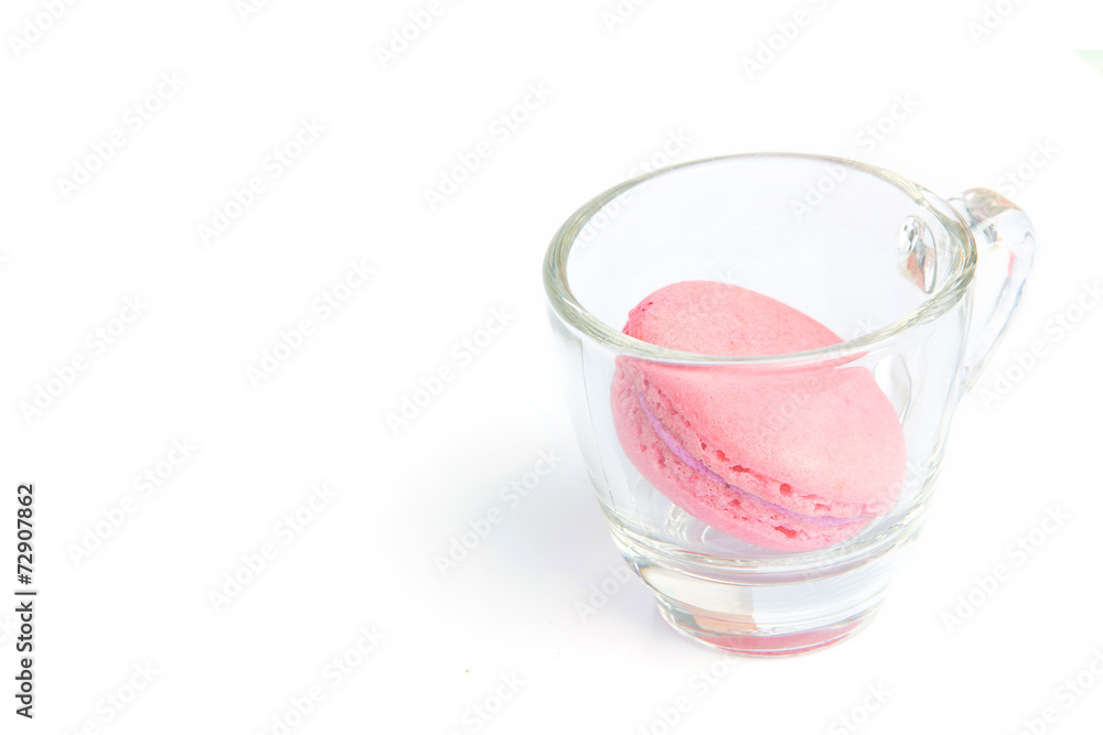 Pink french macarons in the cup on white background