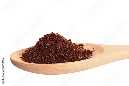 Sumac spice in a wooden spoon, is isolated on a white background