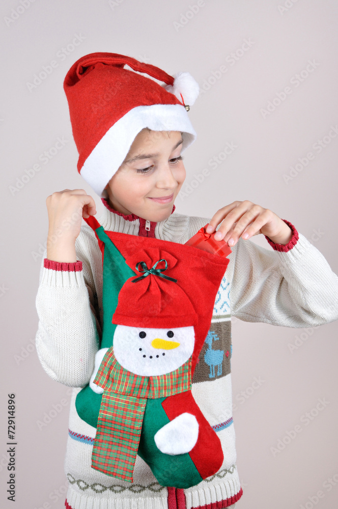 Young boy looking at Christmas present