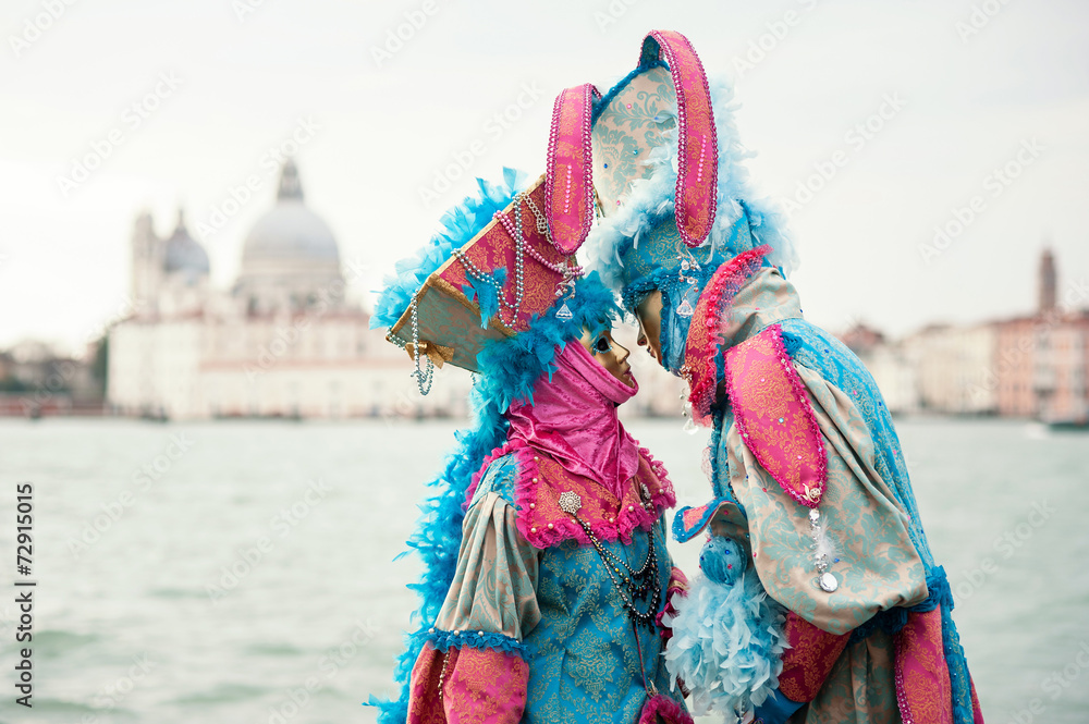 Carnival of Venice, beautiful masks couple at St. George island