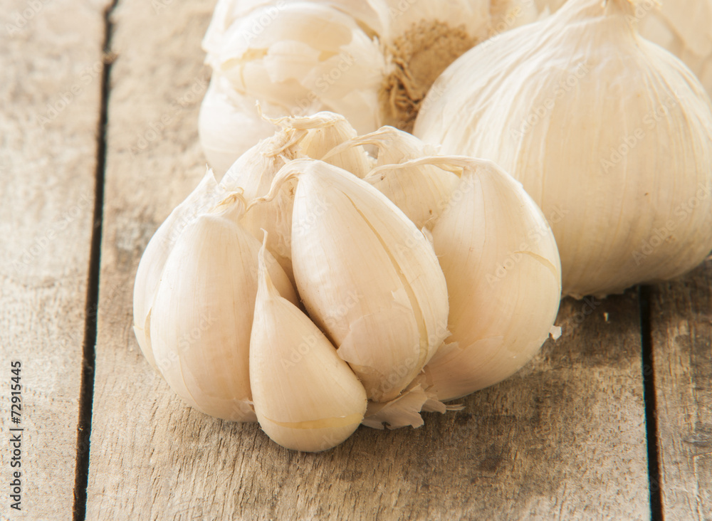 Garlic on wooden background close up