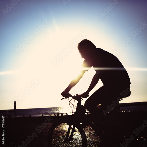 Fototapeta Naklejka Na Ścianę i Meble -  Man on bicycle riding at a coastline