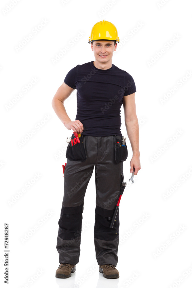 Relaxed manual worker posing with a wrench Relaxed manual worker posing with a wrench