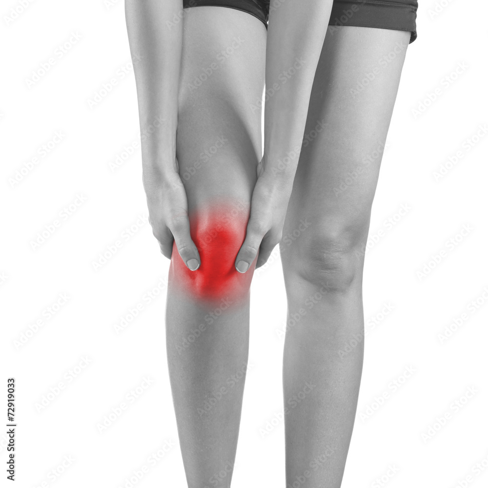 Woman holding injured knee. Woman holding injured knee.
