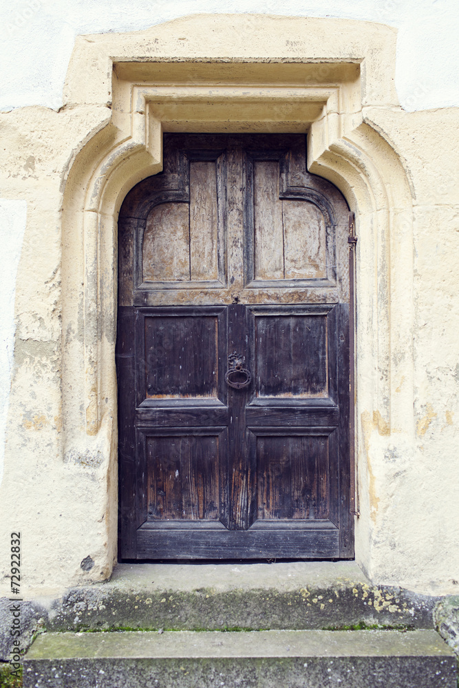 old wood door with metal knob in Prejmer fortified church, Braso