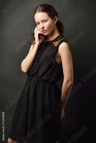 Portrait of the beutiful woman in a black dress.
