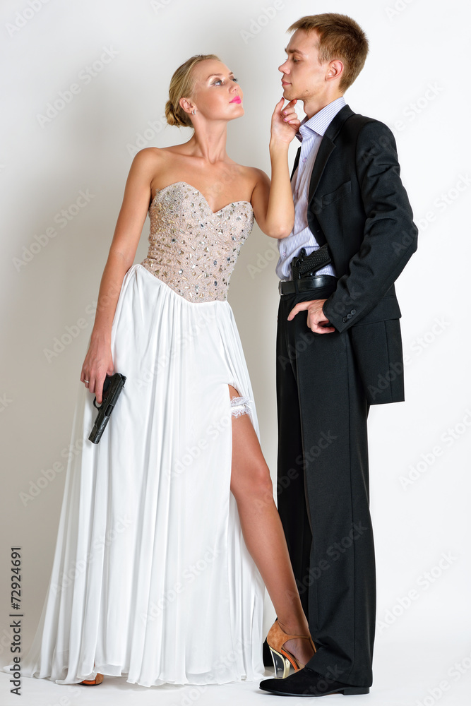 beautiful spy couple in evening dress with a guns. beautiful spy couple in evening dress with a guns.