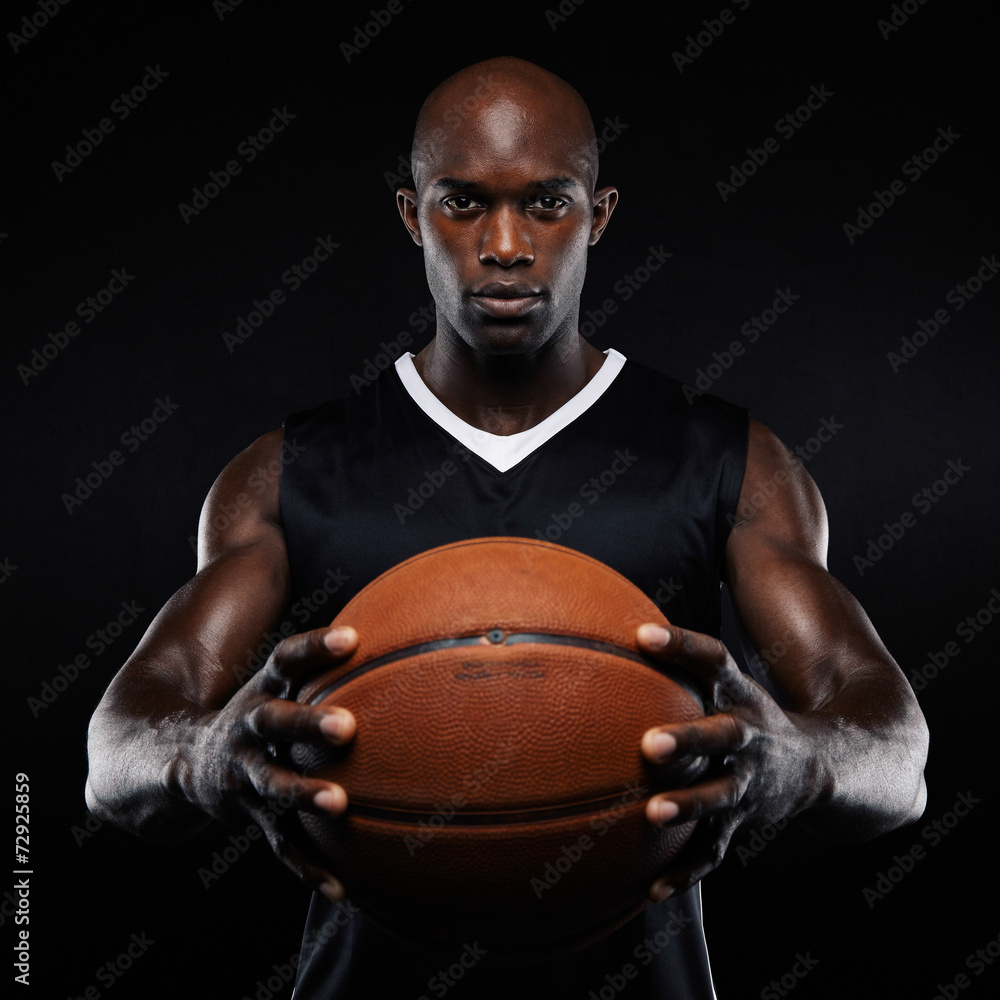 Muscular young basketball player with a ball Muscular young basketball player with a ball