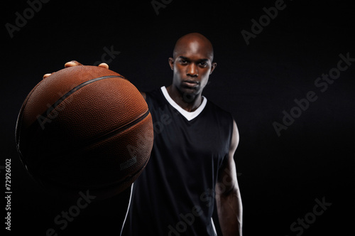 Young man holding a basketball © Jacob Lund