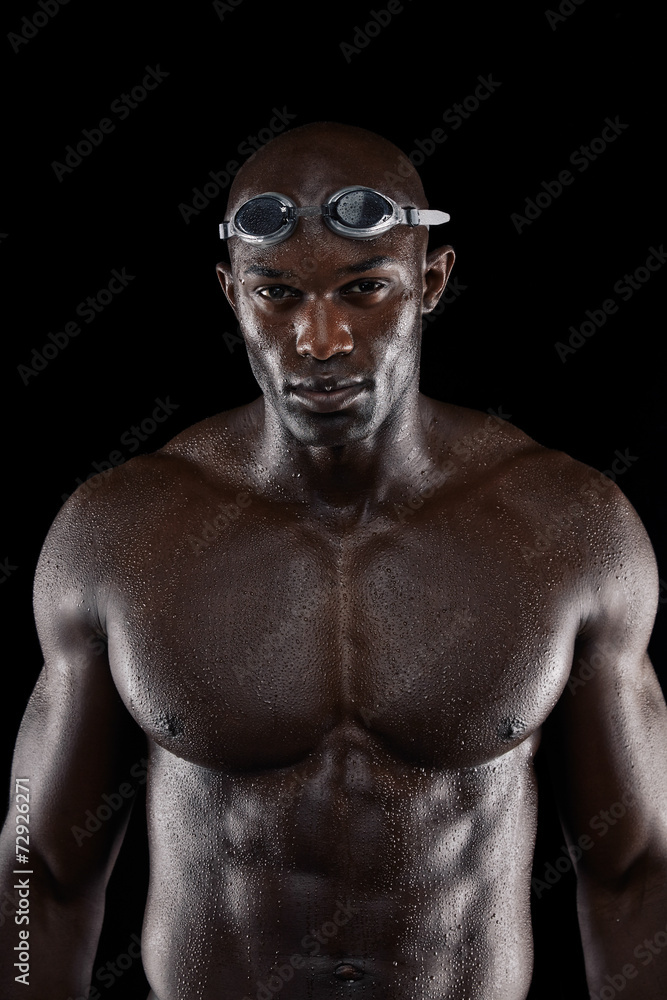 Professional male swimmer on black background Professional male swimmer on black background