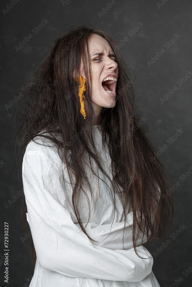 Crazy woman screaming in a straitjacket. Crazy woman screaming in a straitjacket.