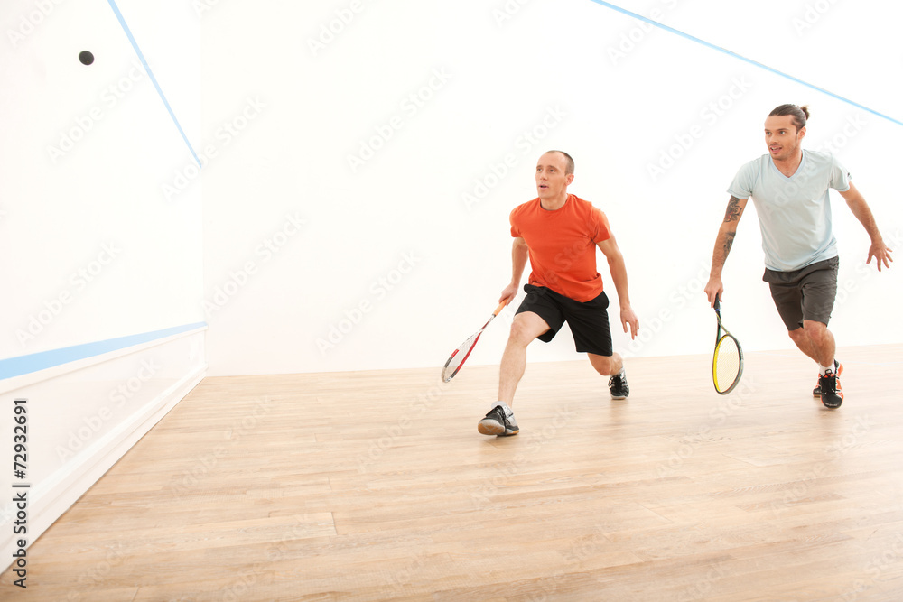 Two men playing match of squash.