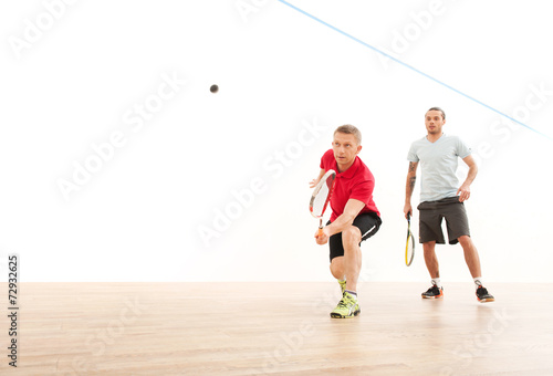 Two men playing match of squash. © BlueSkyImages