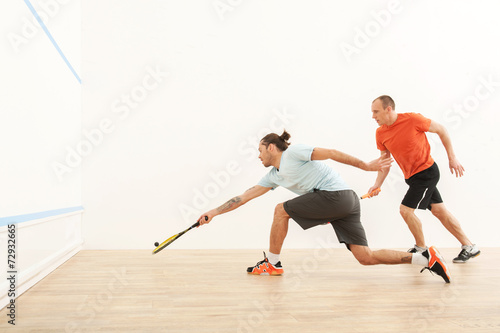 Two men playing match of squash. photo