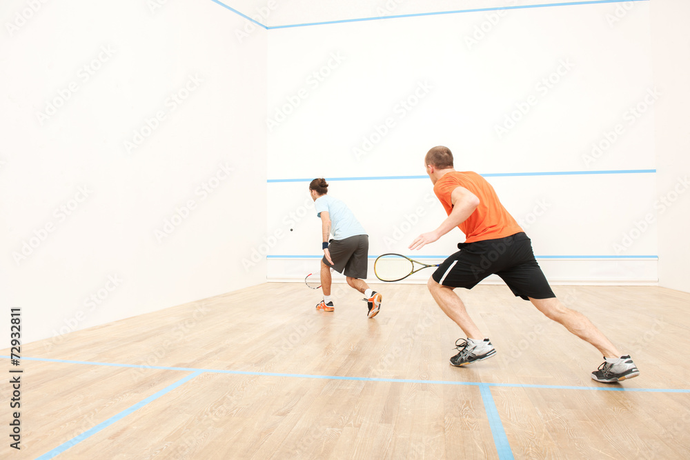 Two men playing match of squash.