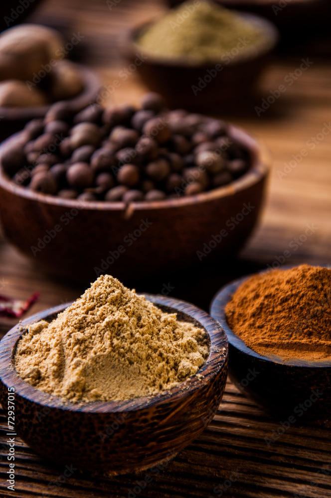 Colorful theme with spices on wooden table Colorful theme with spices on wooden table