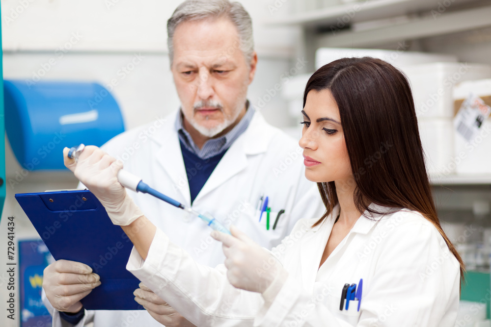 Scientists at work in a laboratory Scientists at work in a laboratory