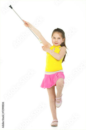 A young elementary-aged drum majorette in uniform