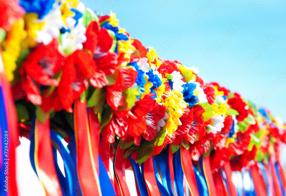Colorful wreaths on blue sky background