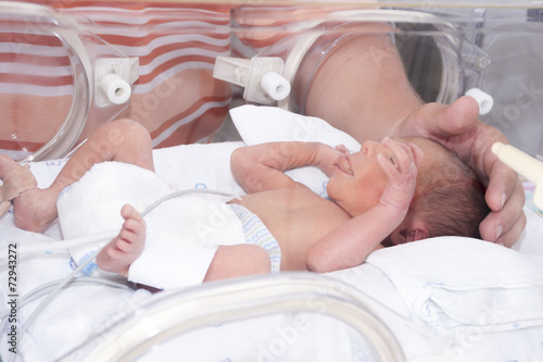 Fotografie Newborn baby inside incubator