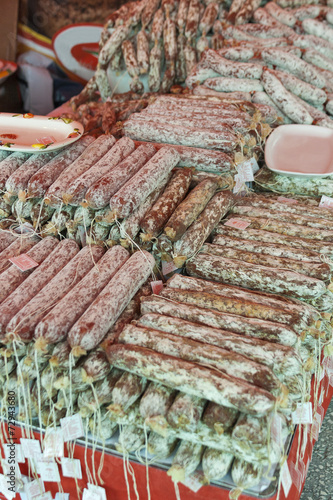salami sticks piled heap in the street market