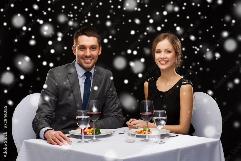 smiling couple eating main course at restaurant smiling couple eating main course at restaurant