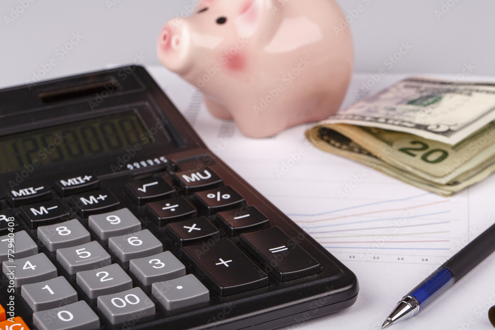 Business Charts with calculator, money, piggy box and pen Business Charts with calculator, money, piggy box and pen