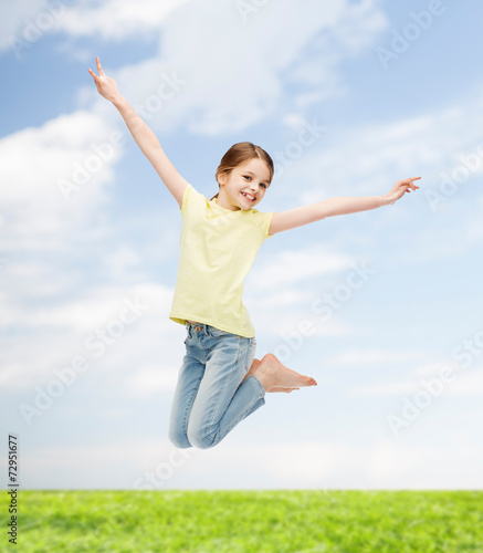 smiling little girl jumping