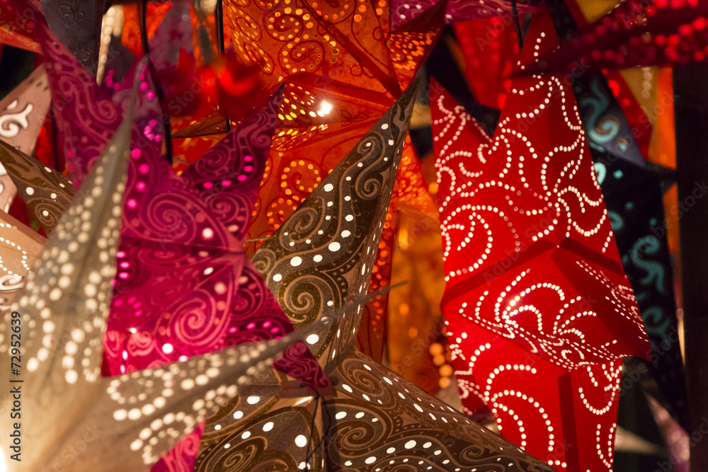 Shiny red golden x-mas stars at european christmas market