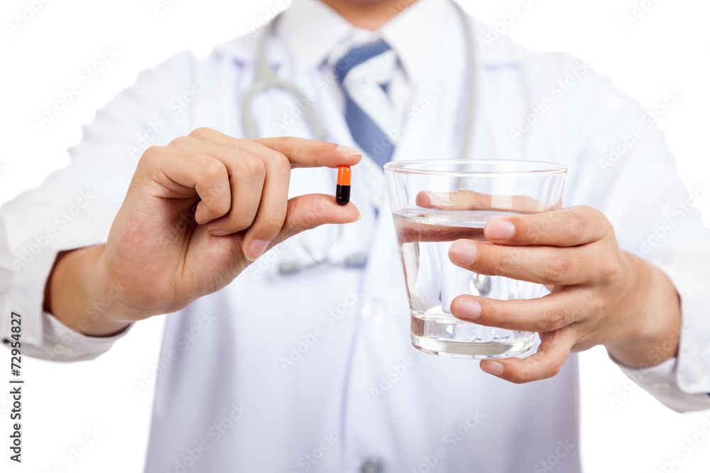 Asian male doctor with a capsule and water Asian male doctor with a capsule and water